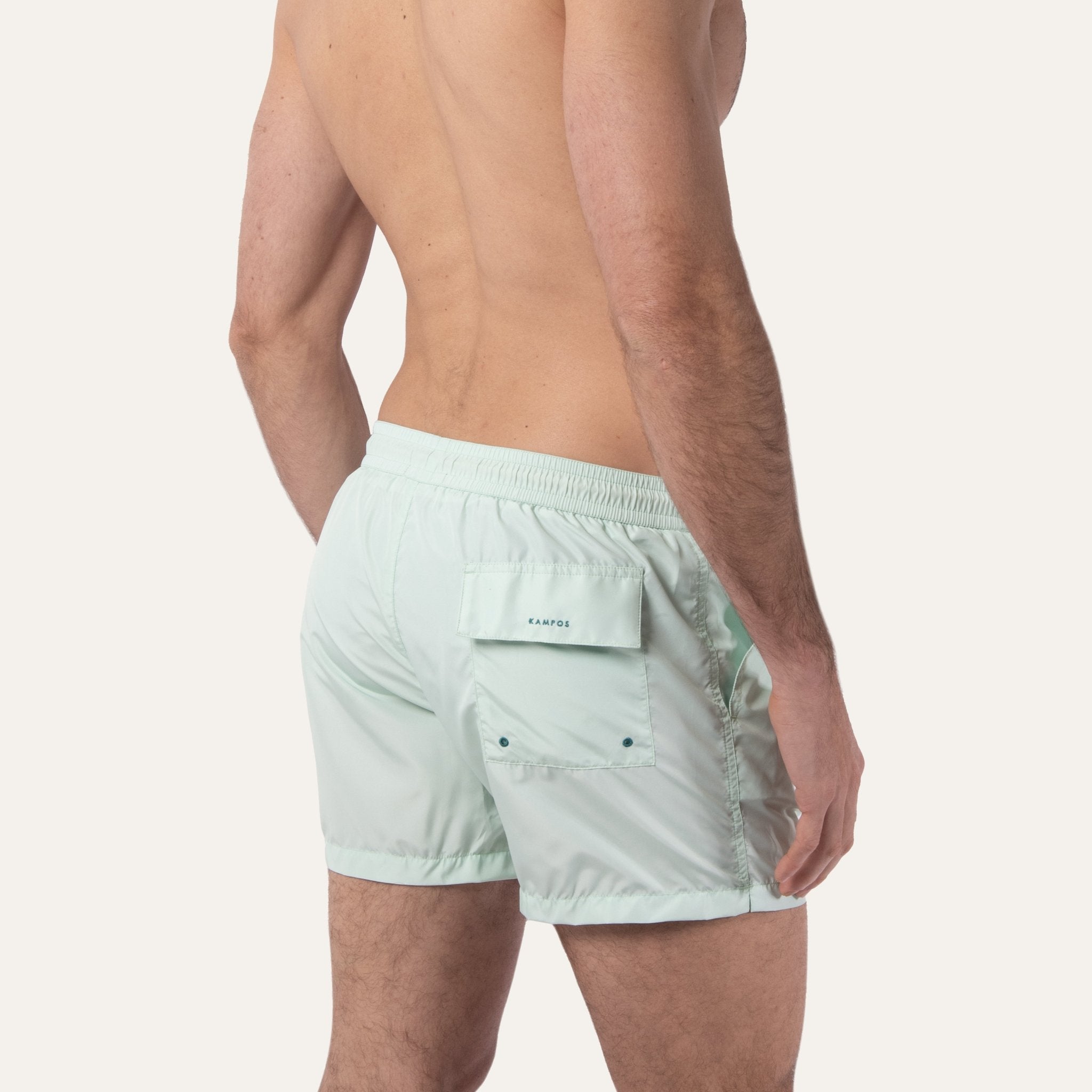 https://cdn.shopify.com/s/files/1/0853/1227/4697/files/k-a-m-p-o-s-swim-shorts-sage-402597.jpg?v=1741947329